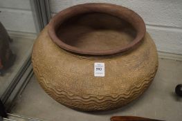 An unusual large, possibly African, incised terracotta circular bowl.