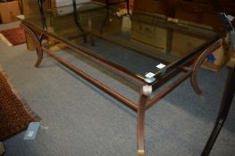 A stylish wrought iron and glass coffee table.