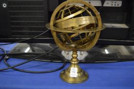 A brass model of a globe.