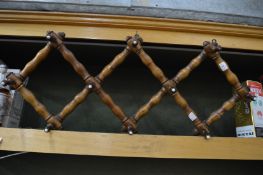 A folding turned wood hat and coat rack.