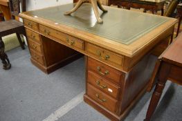 A mahogany partners desk with green leather inset top.