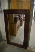 A large rustic pine framed mirror.