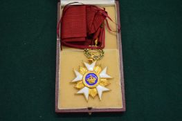 A Belgium gilt metal and enamel badge with ribbon and original box.