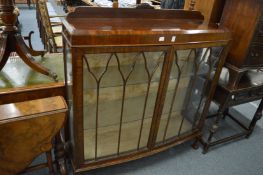 A mahogany bow front two door display cabinet.