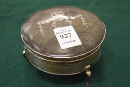 A silver and tortoiseshell trinket box.