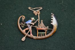 A silver, enamel and marcasite brooch modelled as a Chinaman in a boat.