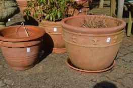 Three terracotta plant pots.