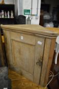 A pine hanging corner cupboard.