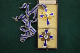 Two medals awarded to German women for giving birth to seven or more children.