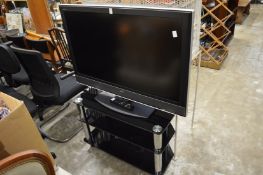 A Sony Bravia TV with stand.