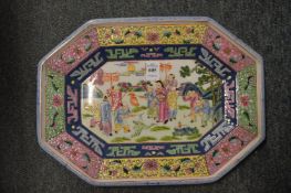 A Chinese famille rose octagonal shaped dish decorated with figures.