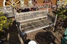 A weathered teak garden bench.