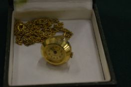 A pendant watch and chain.