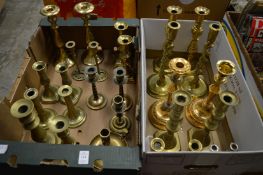 A quantity of brass candlesticks.