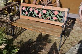A wooden slatted and cast iron garden bench.