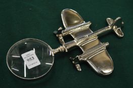 A novelty magnifying glass with aeroplane handle.