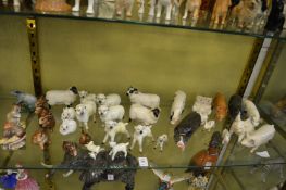A collection of Beswick pigs, sheep and other animals.