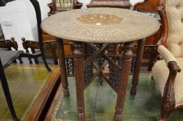 An Eastern brass tray table with folding stand.