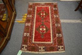 A small Persian design rug, 140cm x 83cm.