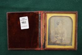 An early photograph of a young lady in a travelling case.