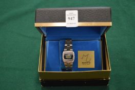 A ladies quartz LCD wristwatch with original box.