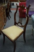 A mahogany occasional chair with lyre shaped back.