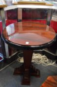 A pair of Art Deco style rosewood stained circular pedestal stands or occasional tables.