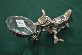 A novelty magnifying glass with motorbike handle.