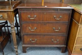 A Georgian design mahogany bachelor's chest with brushing slide and three long drawers.