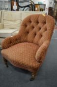 A Victorian button upholstered nursing chair on turned supports with brass castors stamped Cope