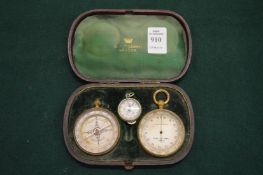 A Negretti & Zambra cased set of pocket barometer and compass together with associated milometer.