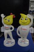 A pair of cast iron Esso figures.