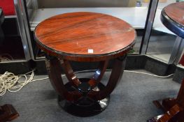 An Art Deco style rosewood stained circular occasional table on curving supports.