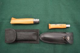 Two Opinel knives with scabbards.