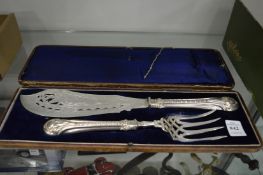 A cased pair of silver plated fish servers.