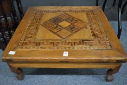 A parquetry inlaid low table.