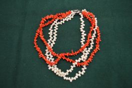 A decorative seed pearl and coral necklace.