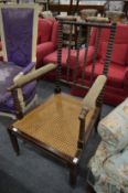 A 19th century bobbin turned armchair with cane work seat.