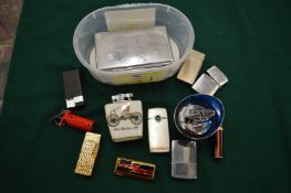 A collection of cigarette lighters etc.