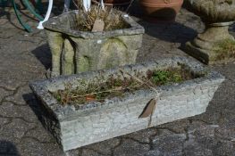 Two weathered reconstituted stone garden planters.