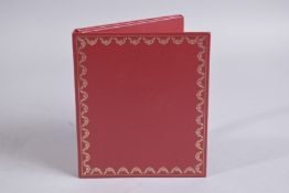 A CARTIER LEATHER NOTEBOOK with DISC. 5.75ins x 5.5ins.
