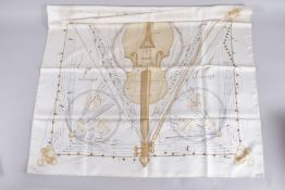 A HERMES SILK MUSIC DESIGN SCARF. 34ins x 36ins, in a Hermes box.