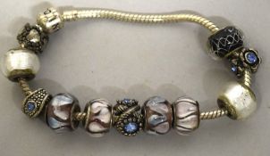 A PANDORA BRACELET AND 10 CHARMS.