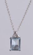 AN 18CT GOLD AQUAMARINE PENDANT on a chain.