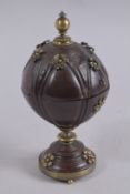 A GOOD CARVED AND BEJEWELLED COCONUT JAR AND COVER. 9ins high.