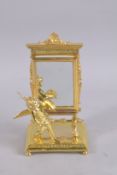 A GOOD GILT BRONZE MIRROR with a cupid. 9ins high.