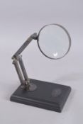 A MAGNIFYING GLASS on a stand.