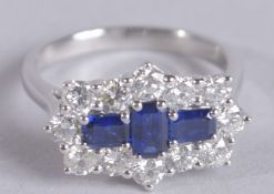 A PLATINUM SAPPHIRE AND DIAMOND BOAT STYLE DRESS RING. Sapphires 0.92ct, RBC diamonds 1.15ct.