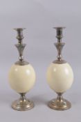 A PAIR OF GARRARD & CO OF LONDON OSTRICH EGG CANDLESTICKS. 14.5ins high.