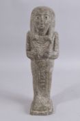 AN EGYPTIAN CARVED STONE FIGURE OF A PHARAOH. 15ins high.